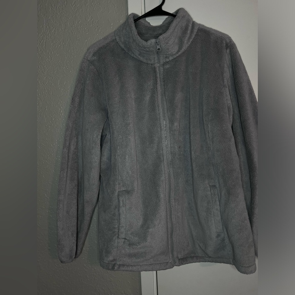 Woman’s grey sweater.